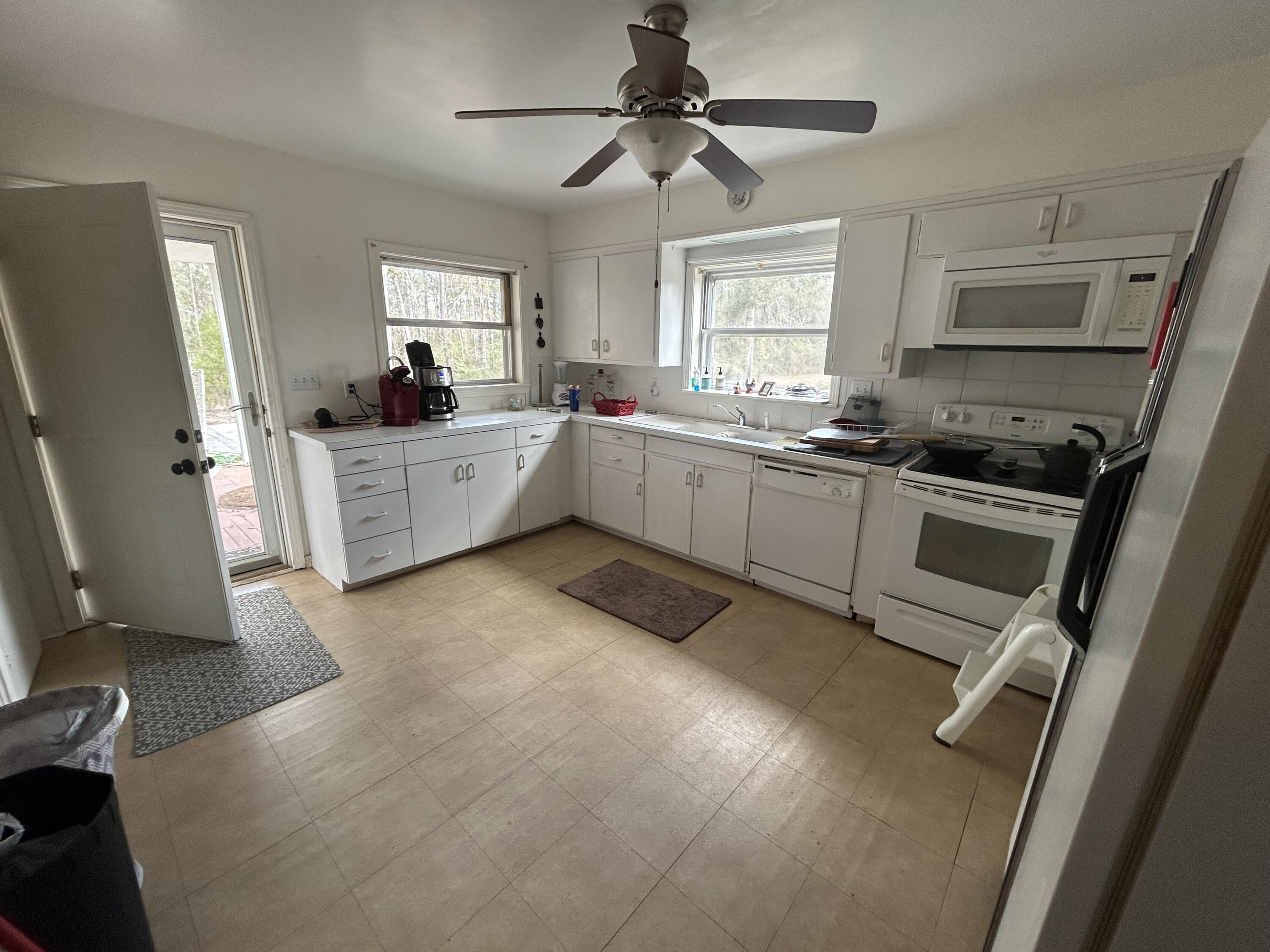 7151 Co Highway 280 DeFuniak Springs, FL 32435 - Photo 7 of 15 a kitchen with a sink stove and refrigerator