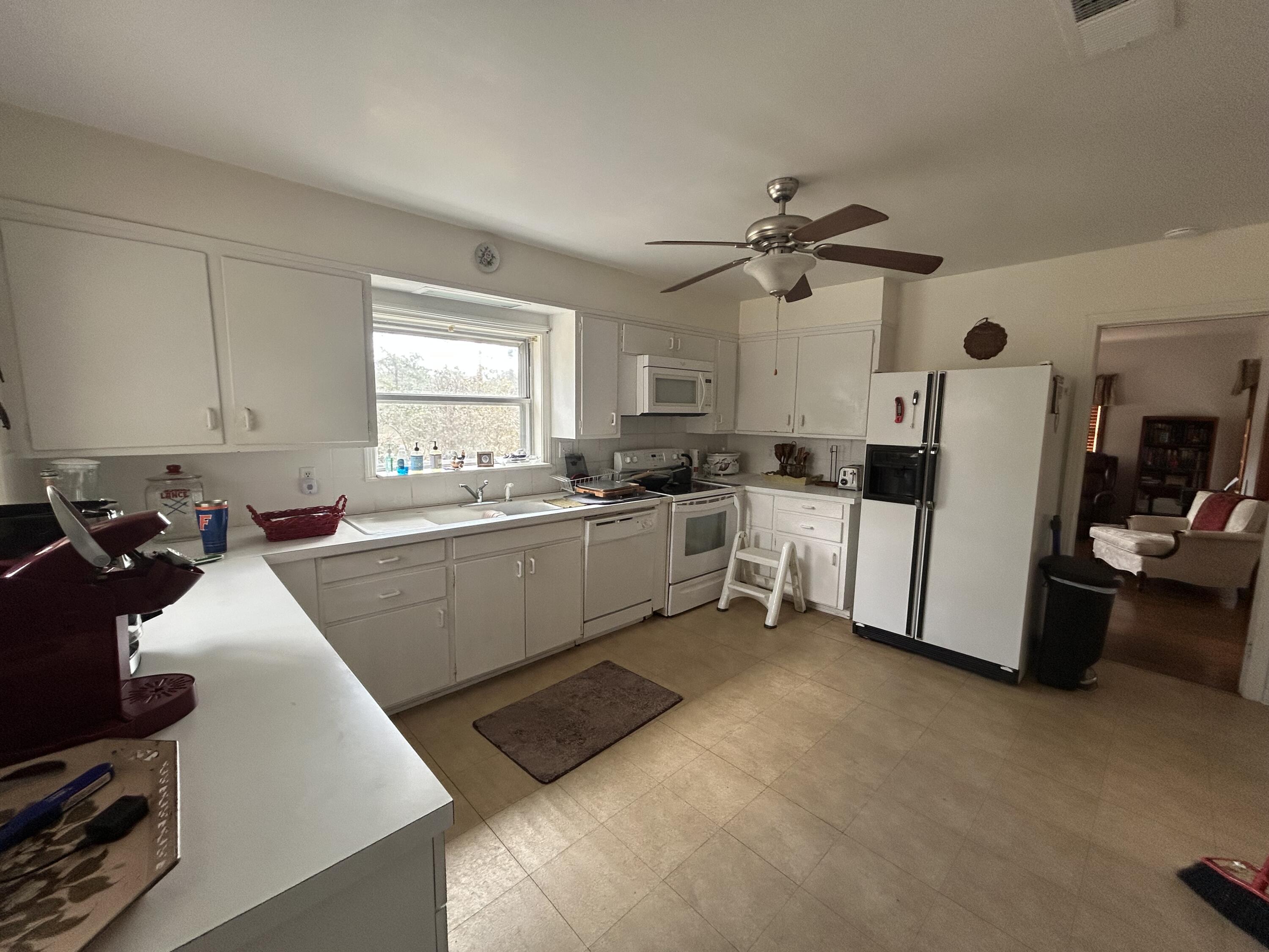 7151 Co Highway 280 DeFuniak Springs, FL 32435 - Photo 8 of 15 a kitchen with white cabinets and white appliances