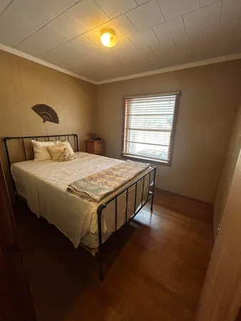 a bed sitting in a bedroom next to a window