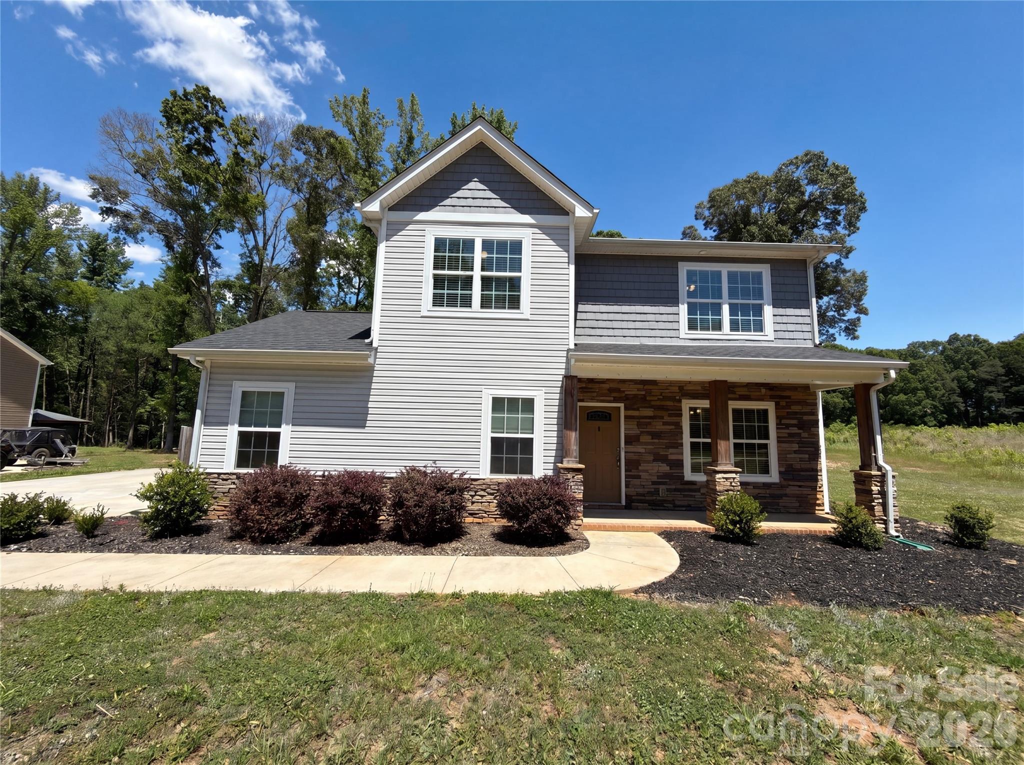 4918 Griffith Road Monroe, NC 28112 - Photo 1 of 17 a front view of a house with a yard and potted plants