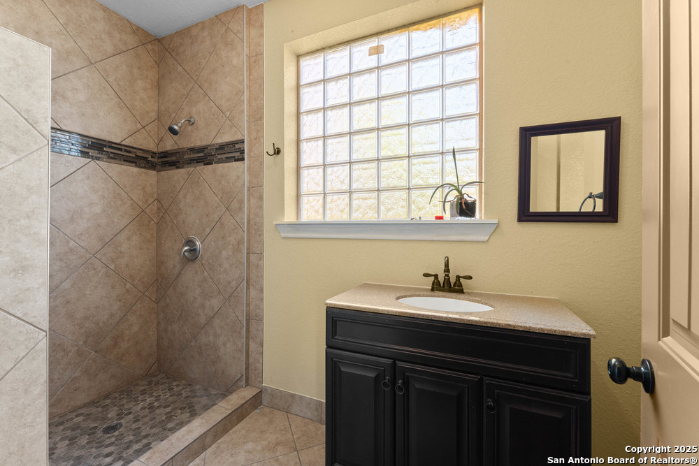 2930 Shane Road San Antonio, TX 78223 - Photo 13 of 75 a bathroom with a sink and a mirror
