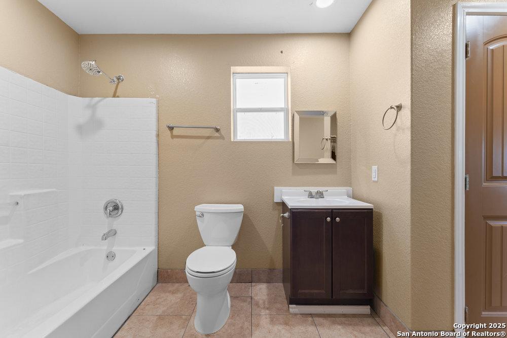 2930 Shane Road San Antonio, TX 78223 - Photo 17 of 75 a bathroom with a sink a toilet and shower