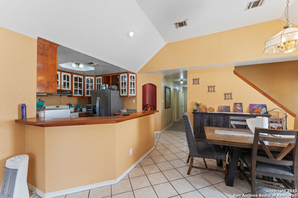 2930 Shane Road San Antonio, TX 78223 - Photo 23 of 75 a dining room with furniture and a floor to ceiling window
