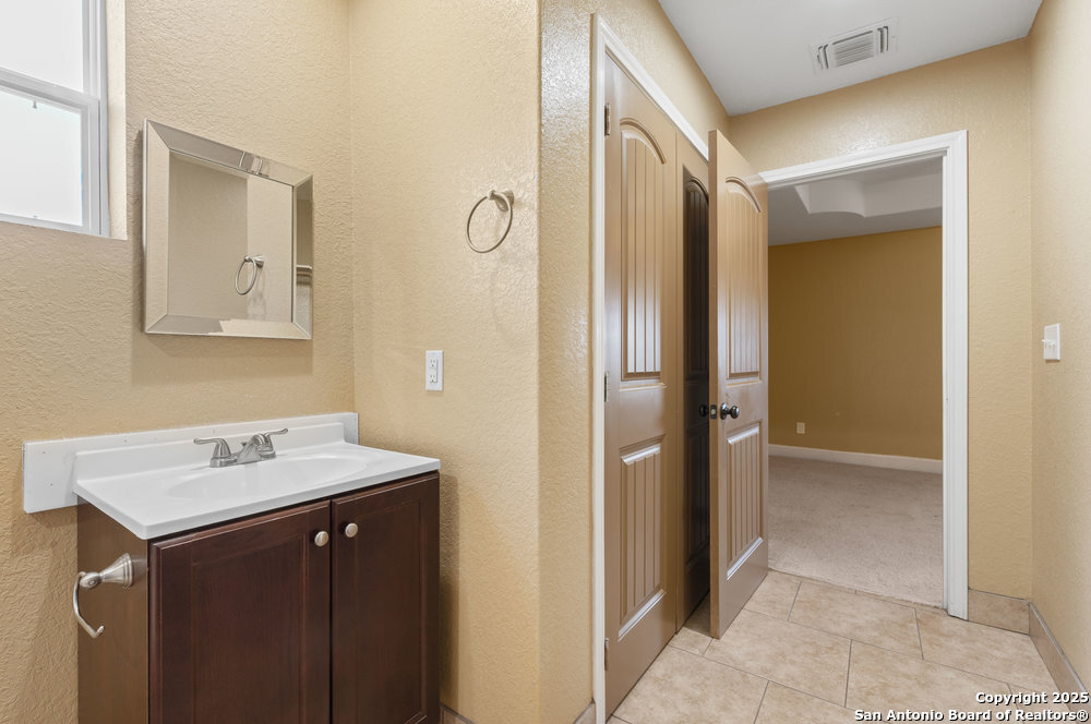 2930 Shane Road San Antonio, TX 78223 - Photo 25 of 75 a bathroom with a sink and a mirror