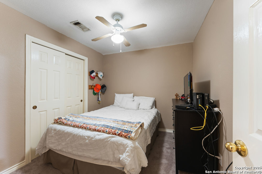 2930 Shane Road San Antonio, TX 78223 - Photo 31 of 75 a bedroom with a bed and a chandelier