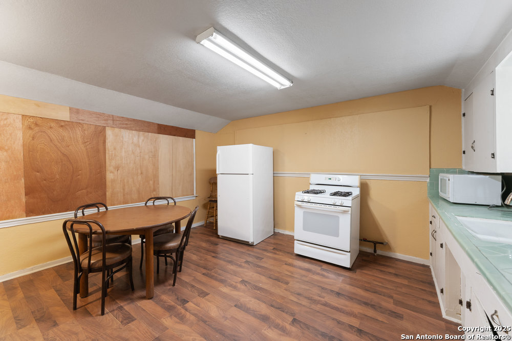 2930 Shane Road San Antonio, TX 78223 - Photo 37 of 75 a kitchen with a table chairs a stove and a refrigerator