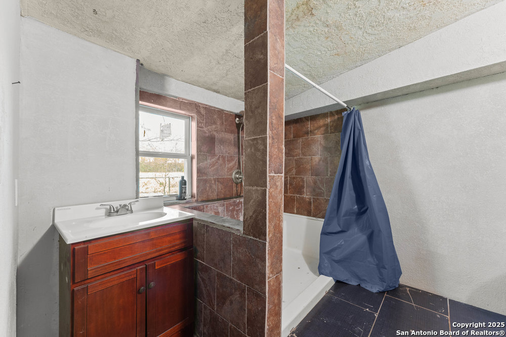 2930 Shane Road San Antonio, TX 78223 - Photo 38 of 75 a bathroom with a sink and a mirror