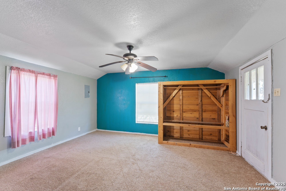 2930 Shane Road San Antonio, TX 78223 - Photo 43 of 75 an empty room with chandelier fan and windows
