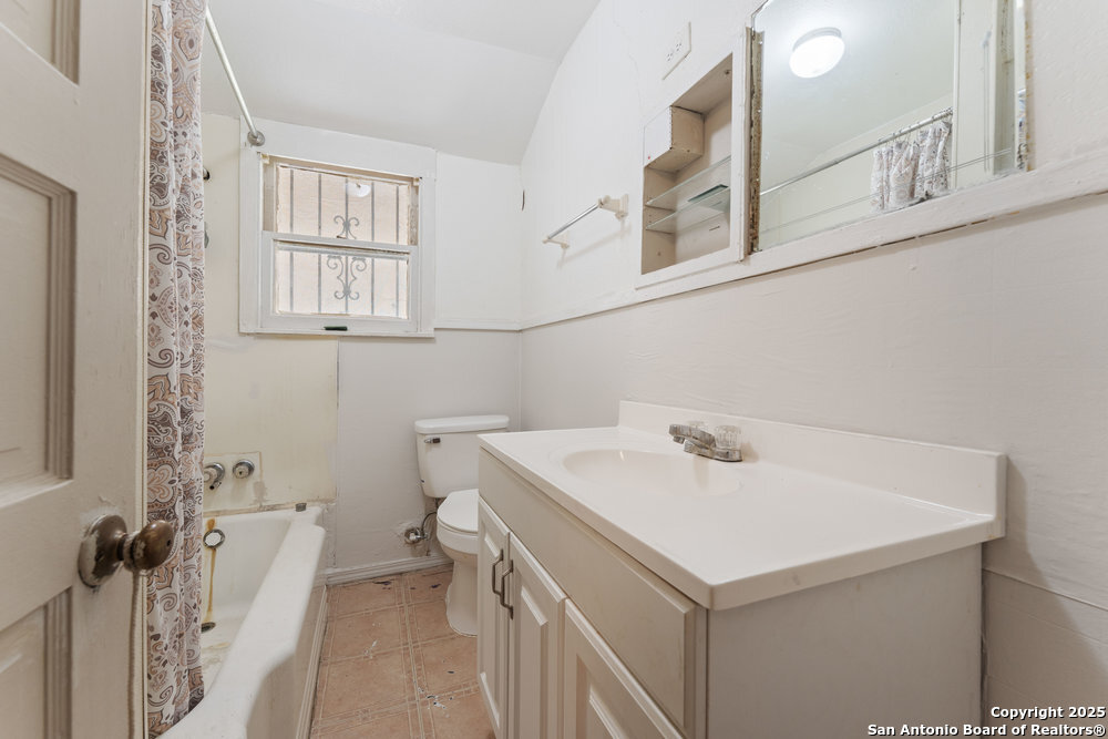 2930 Shane Road San Antonio, TX 78223 - Photo 45 of 75 a bathroom with a sink a toilet and a window