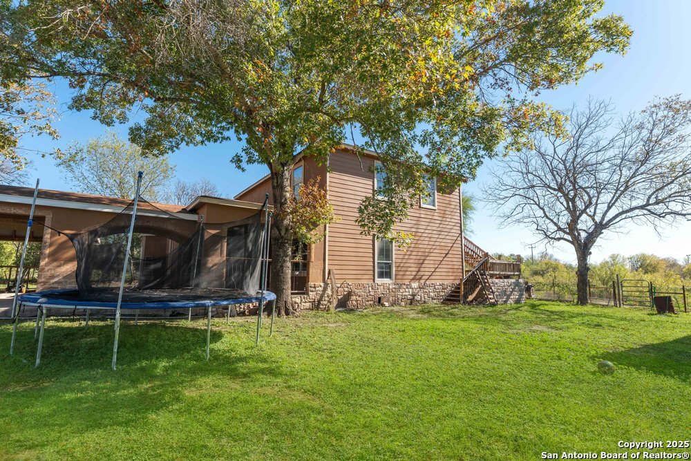 2930 Shane Road San Antonio, TX 78223 - Photo 59 of 75 a view of backyard with wooden fence and a large tree