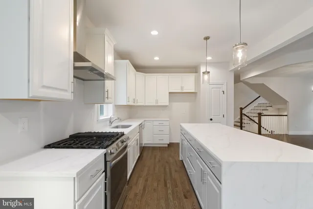 a kitchen with a stove a sink and a refrigerator