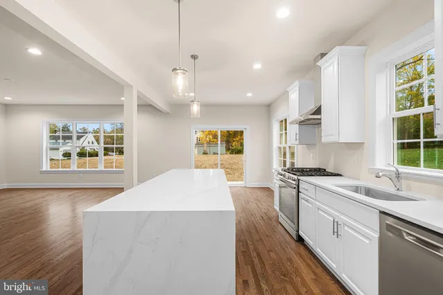 a view of kitchen with sink and wooden floor