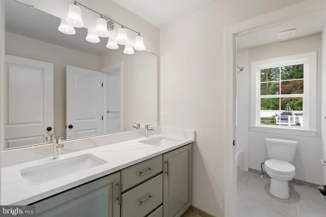 a white toilet sitting next to a bath tub