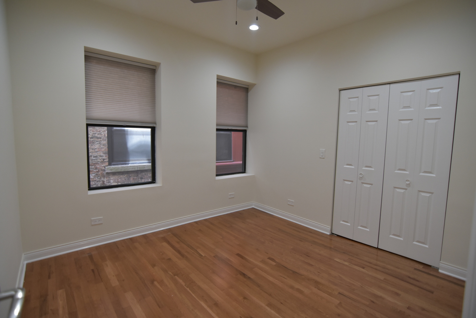 732 West Grace Street, Unit 2W Chicago, IL 60613 - Photo 12 of 15 a view of an empty room with wooden floor and a window