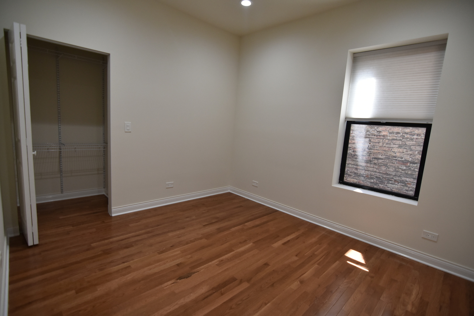 732 West Grace Street, Unit 2W Chicago, IL 60613 - Photo 14 of 15 an empty room with wooden floor and windows