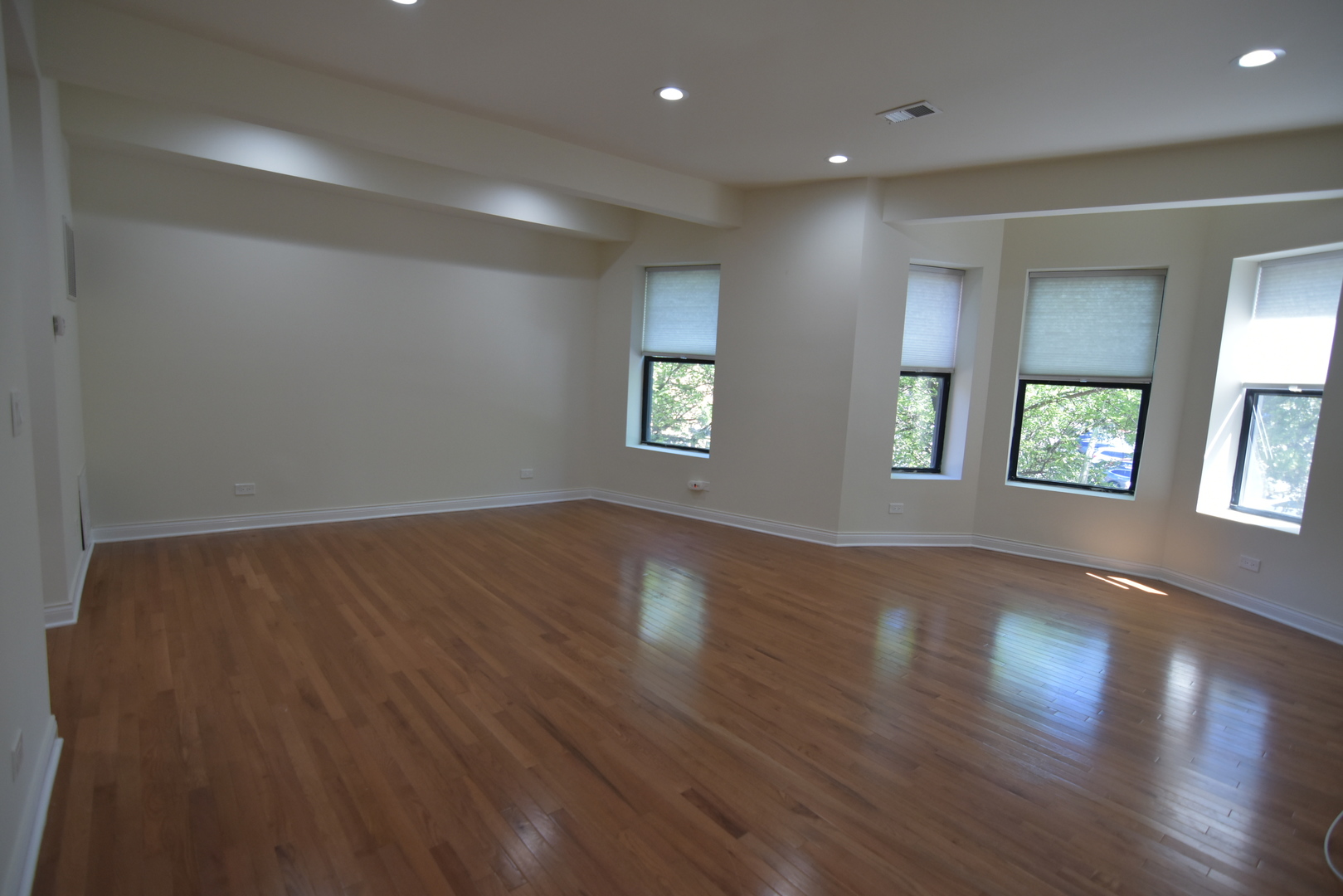 732 West Grace Street, Unit 2W Chicago, IL 60613 - Photo 2 of 15 a view of an empty room with wooden floor and a window