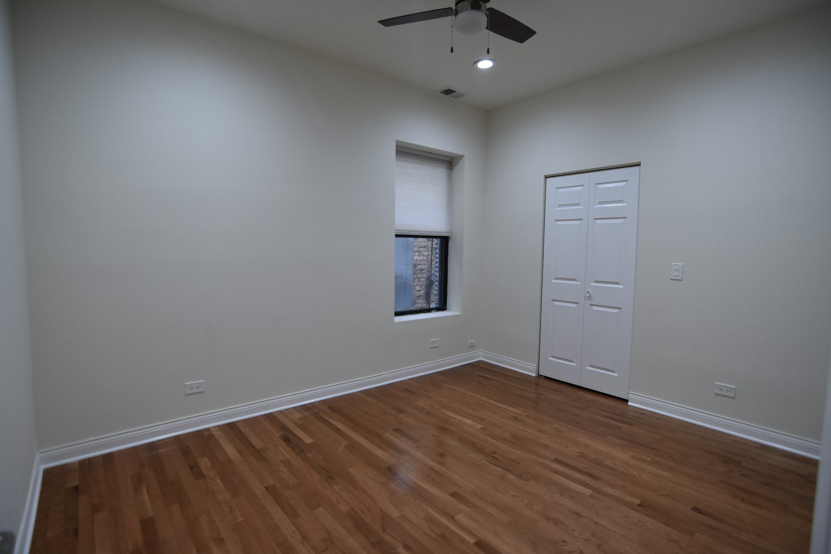 732 West Grace Street, Unit 2W Chicago, IL 60613 - Photo 10 of 15 an empty room with wooden floor and windows