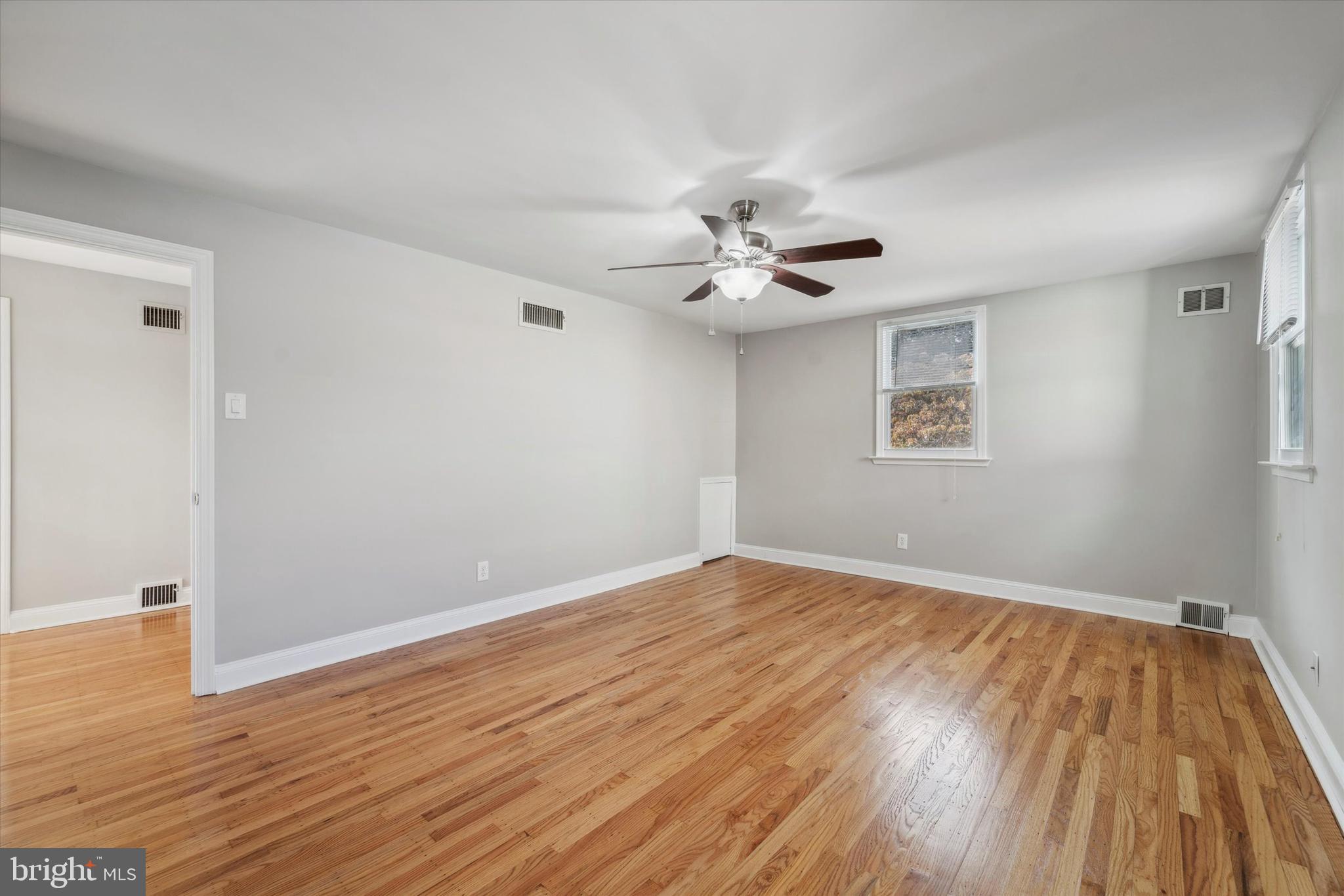 1718 Mt Pleasant Road Havertown, PA 19083 - Photo 13 of 30 a view of an empty room with wooden floor and a window