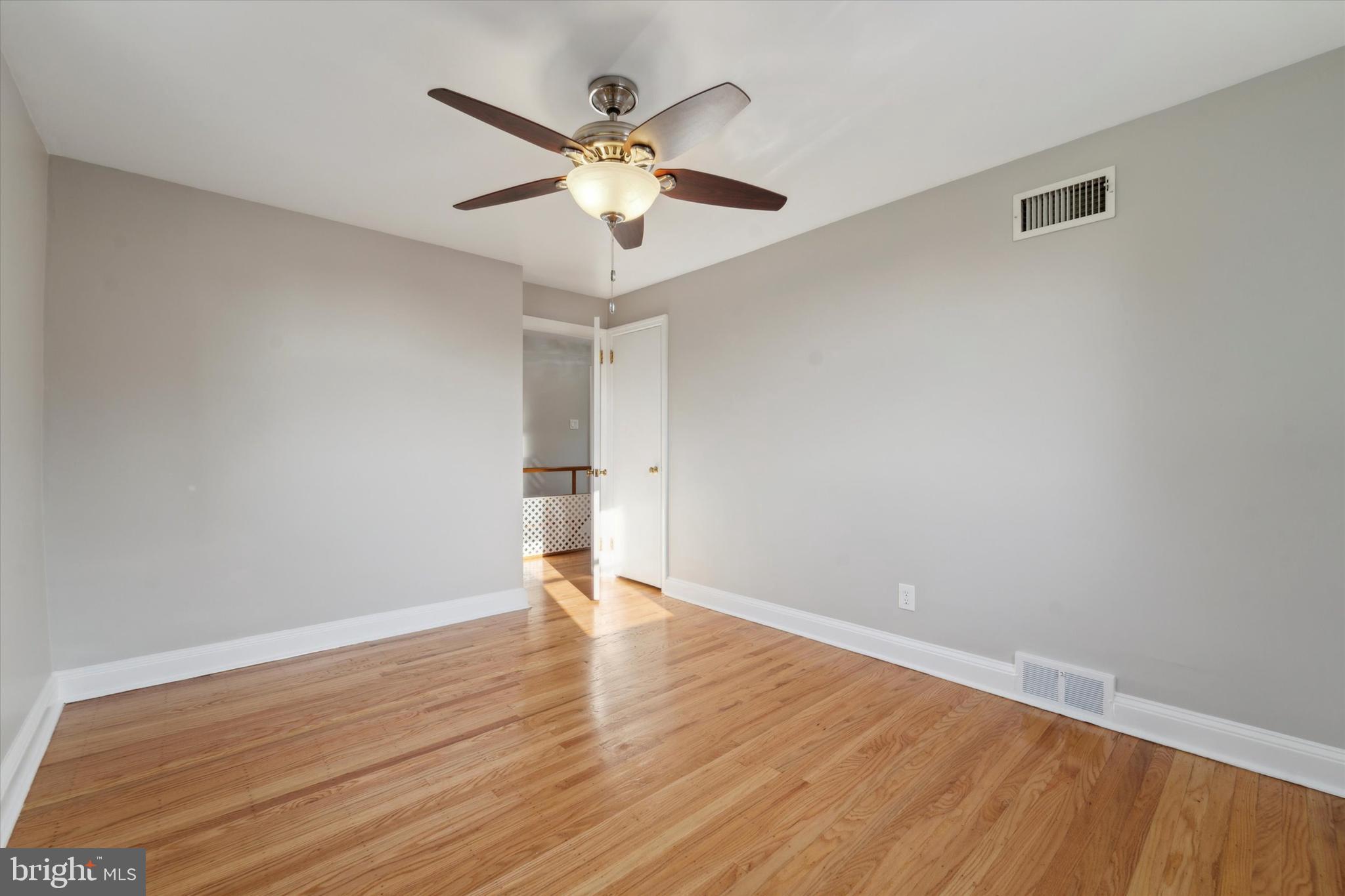 1718 Mt Pleasant Road Havertown, PA 19083 - Photo 16 of 30 an empty room with wooden floor and ceiling fan