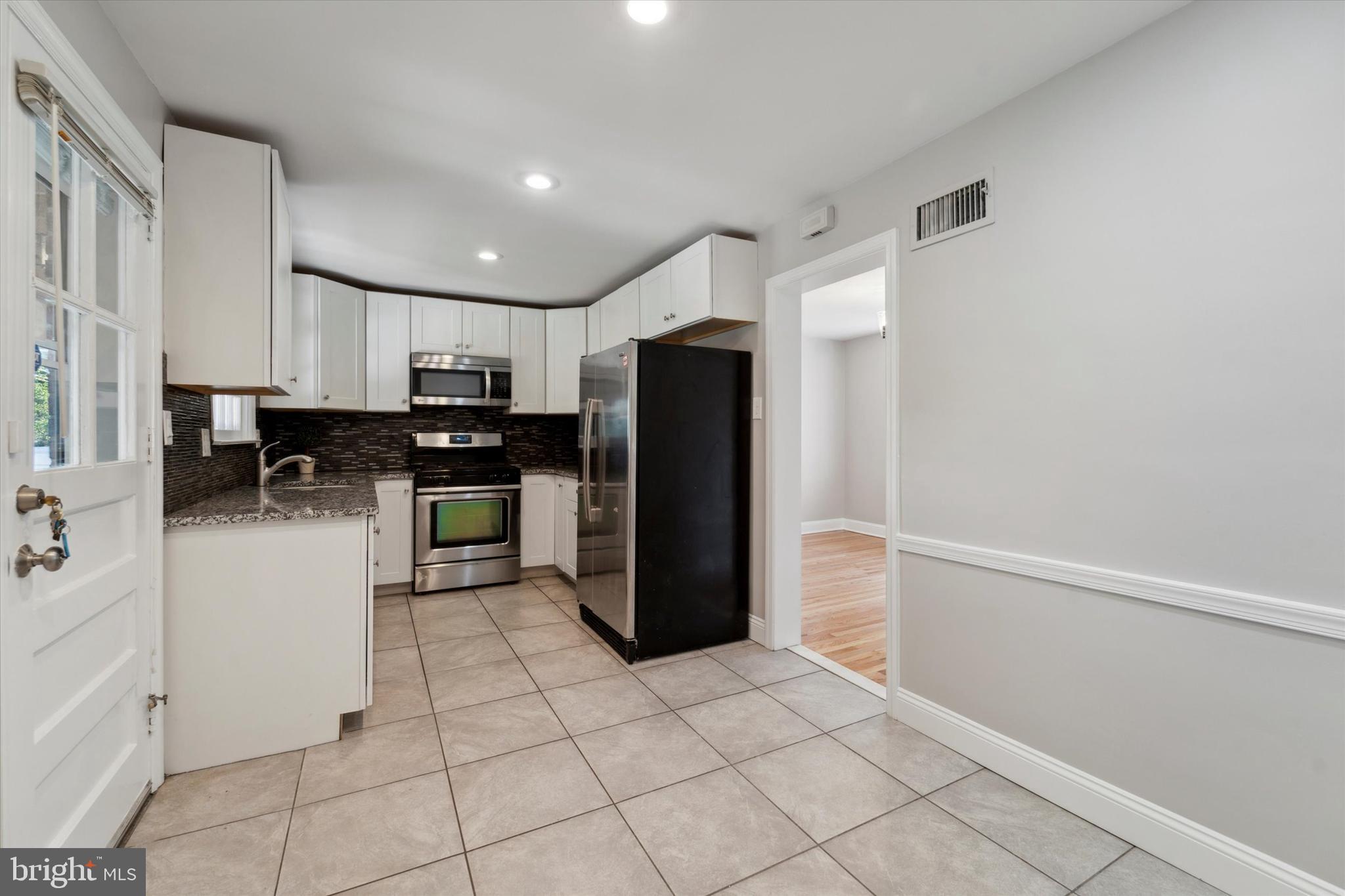 1718 Mt Pleasant Road Havertown, PA 19083 - Photo 7 of 30 a kitchen with stainless steel appliances a refrigerator sink and cabinets