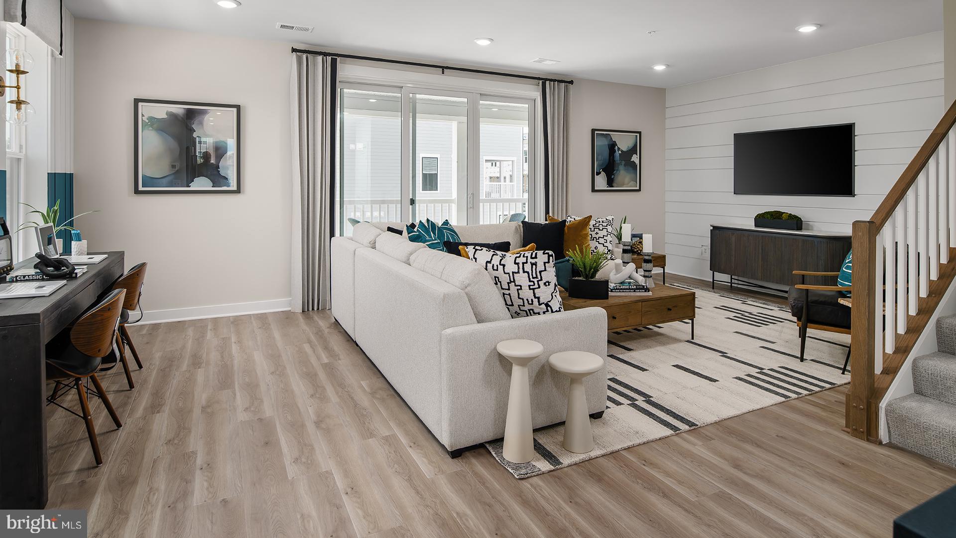 Tbb Cloongee Terrace, Unit CLARENDON Sterling, VA 20166 - Photo 5 of 14 a living room with furniture a flat screen tv and a wooden floor