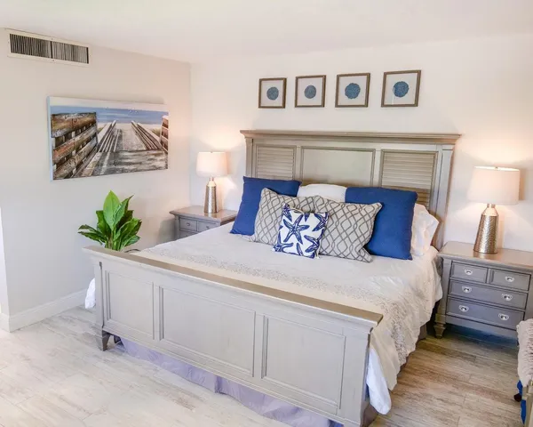 a bedroom with a bed and a potted plant