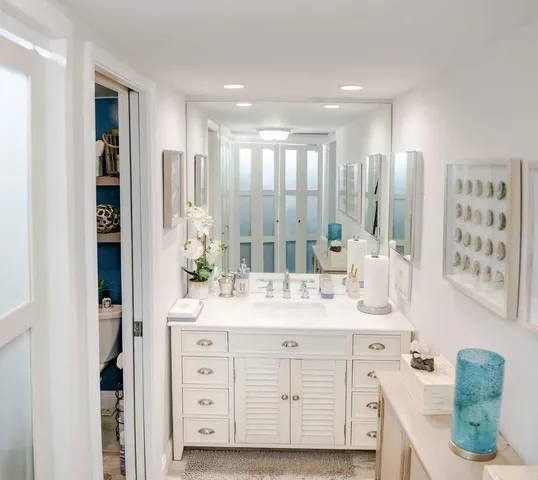 a bathroom with a double vanity sink a mirror a and shower
