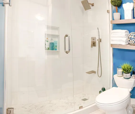 a white toilet sitting next to a bath tub shower