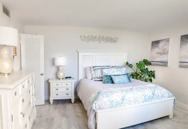 a bedroom with a bed and a lamp