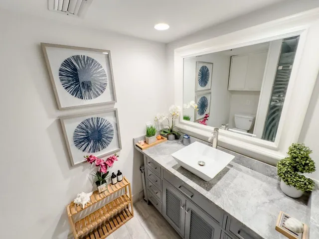 a bathroom with a sink mirror and vanity