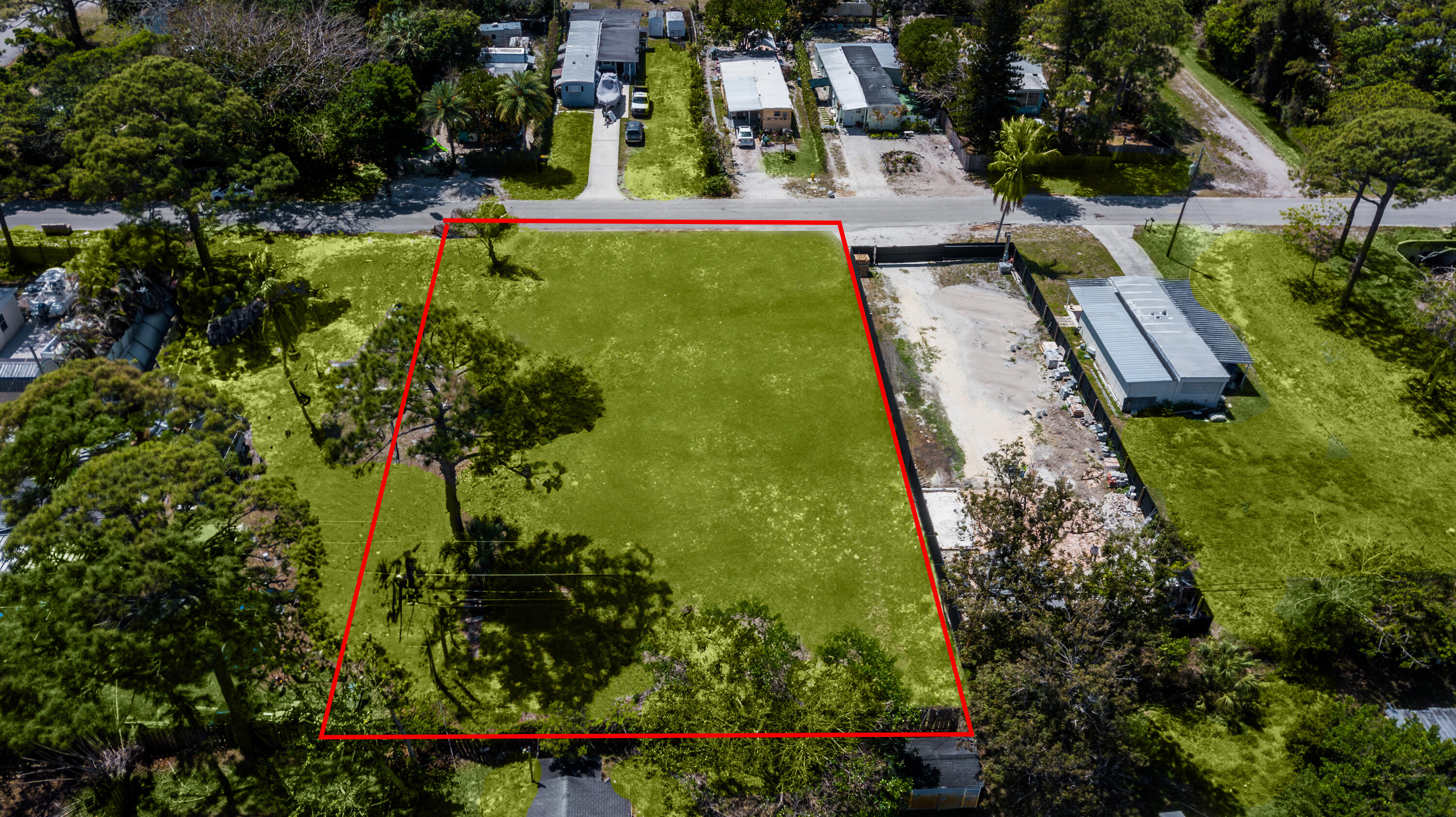 5279 Southeast Isabelita Avenue Stuart, FL 34997 - Photo 7 of 8 an aerial view of residential houses with outdoor space and trees