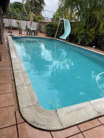 a view of a swimming pool with a lounge chair