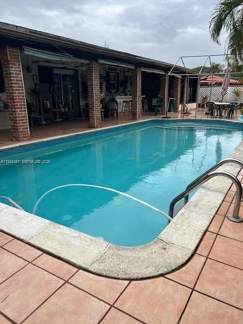9832 Southwest 27th Terrace Miami, FL 33165 - Photo 13 of 13 a view of a swimming pool with a lounge chair