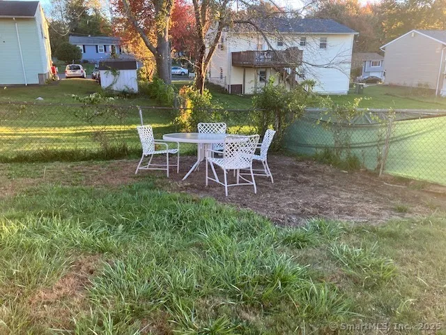 a view of a chairs and table in the garden