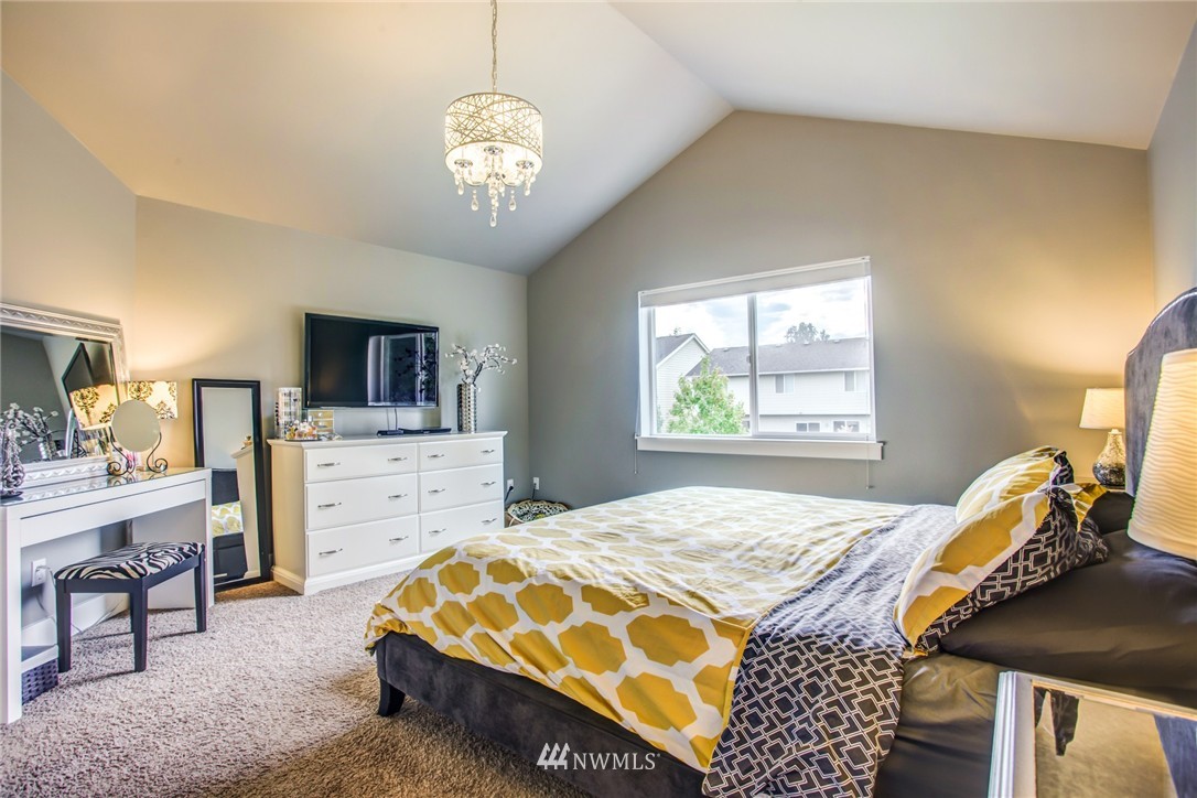 5117 Northeast 11th Street Renton, WA 98059 - Photo 12 of 19 a bedroom with a bed and a chandelier