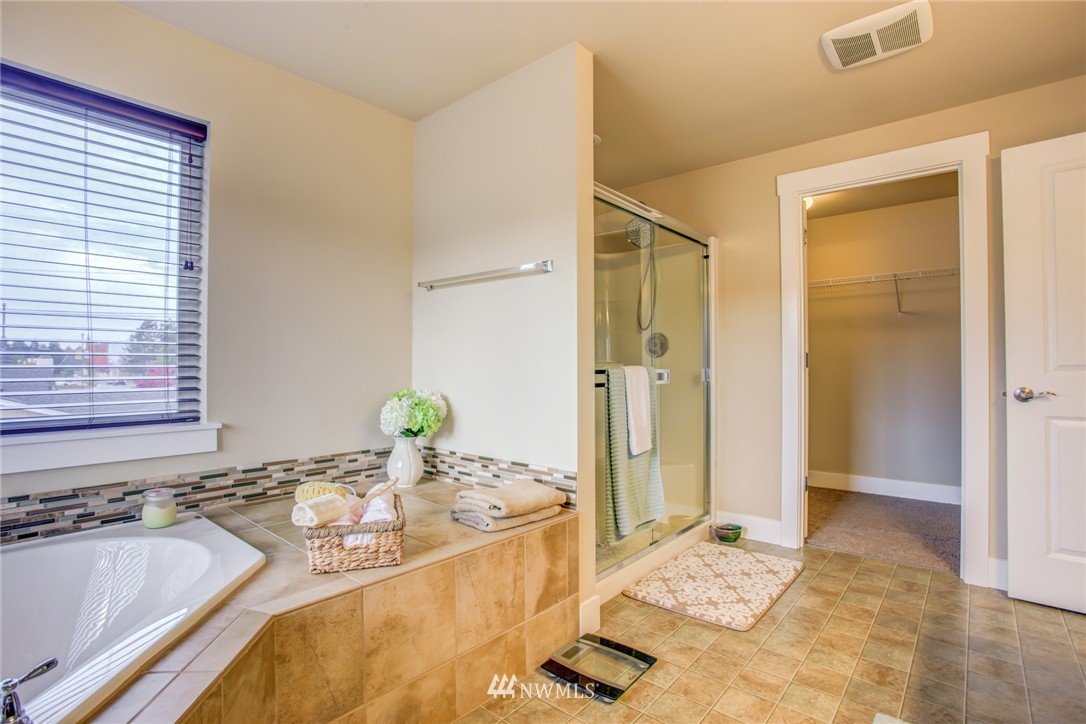 5117 Northeast 11th Street Renton, WA 98059 - Photo 14 of 19 a bathroom with a granite countertop sink and a tub