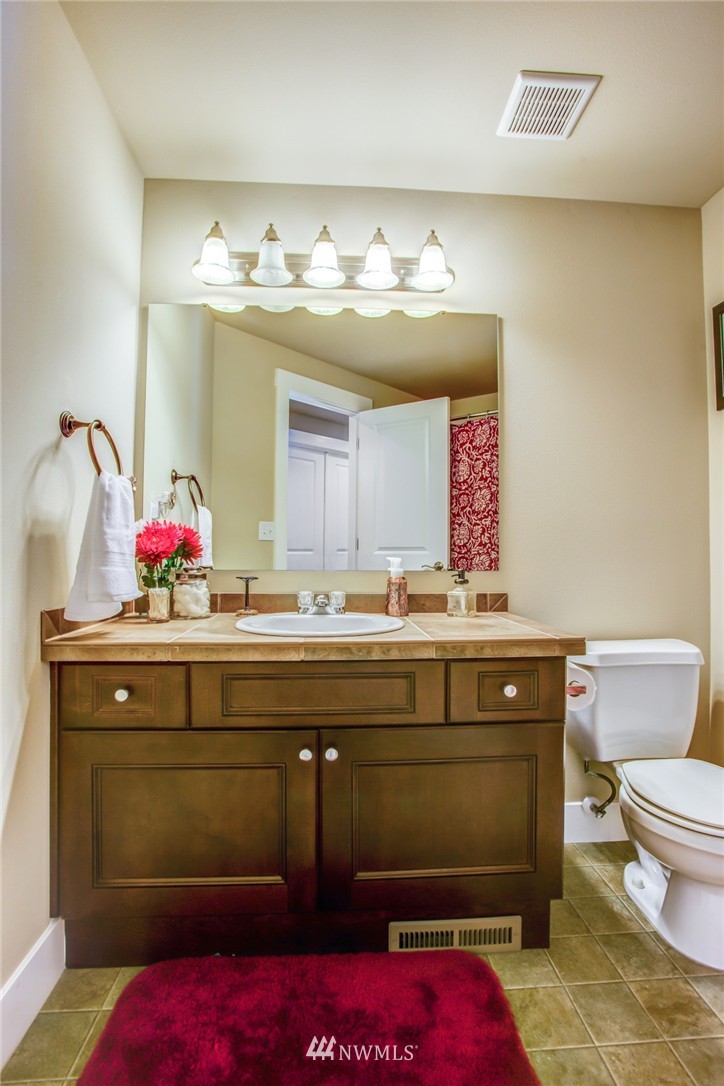 5117 Northeast 11th Street Renton, WA 98059 - Photo 17 of 19 a bathroom with a sink and a mirror