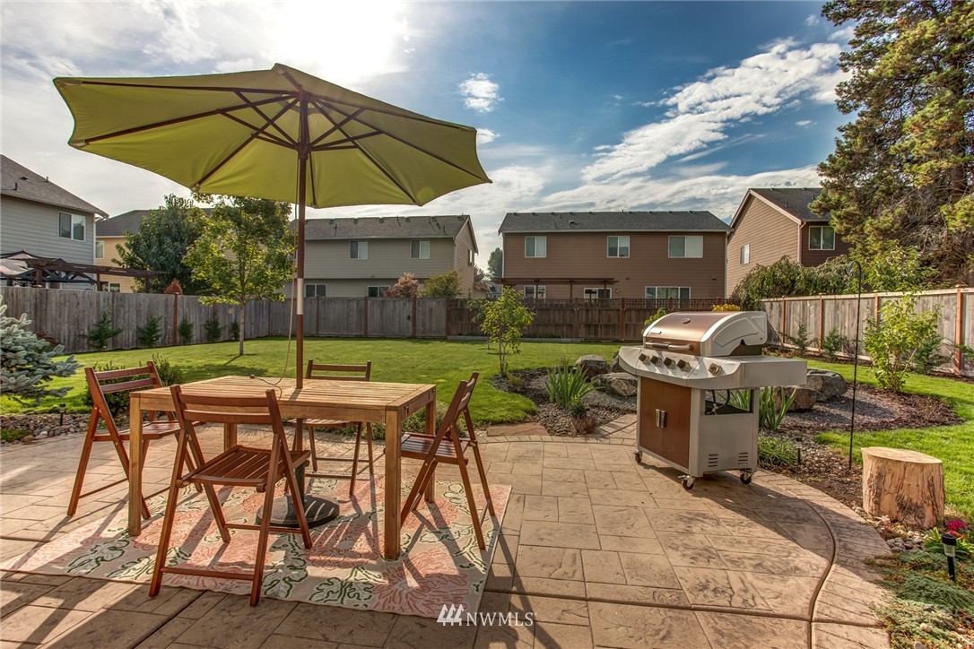 5117 Northeast 11th Street Renton, WA 98059 - Photo 19 of 19 a view of a patio with a table and chairs under an umbrella