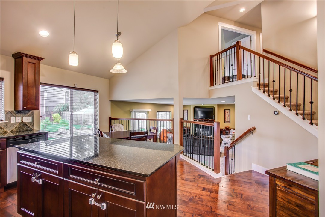 5117 Northeast 11th Street Renton, WA 98059 - Photo 5 of 19 a kitchen with stainless steel appliances granite countertop a sink a stove and a wooden floors