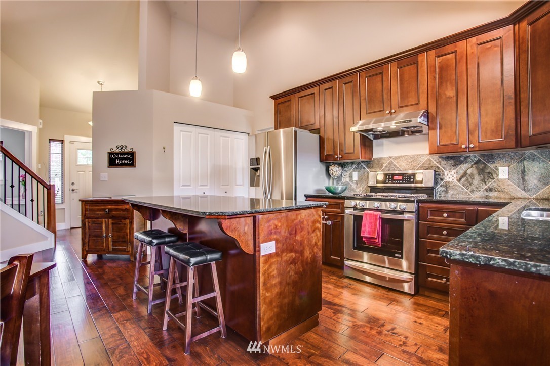 5117 Northeast 11th Street Renton, WA 98059 - Photo 6 of 19 a kitchen with stainless steel appliances granite countertop a stove a sink and a refrigerator