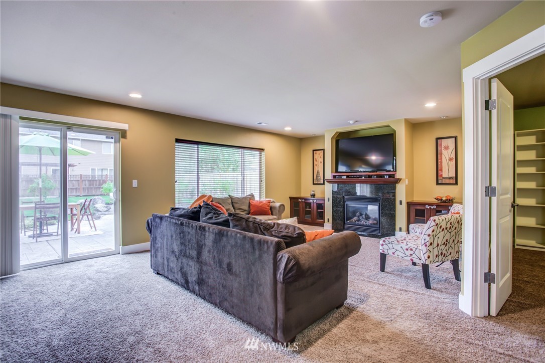 5117 Northeast 11th Street Renton, WA 98059 - Photo 8 of 19 a living room with furniture a flat screen tv and a large window