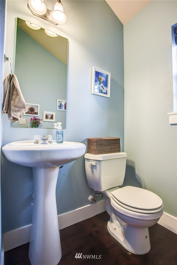 5117 Northeast 11th Street Renton, WA 98059 - Photo 10 of 19 a bathroom with a sink toilet mirror and vanity