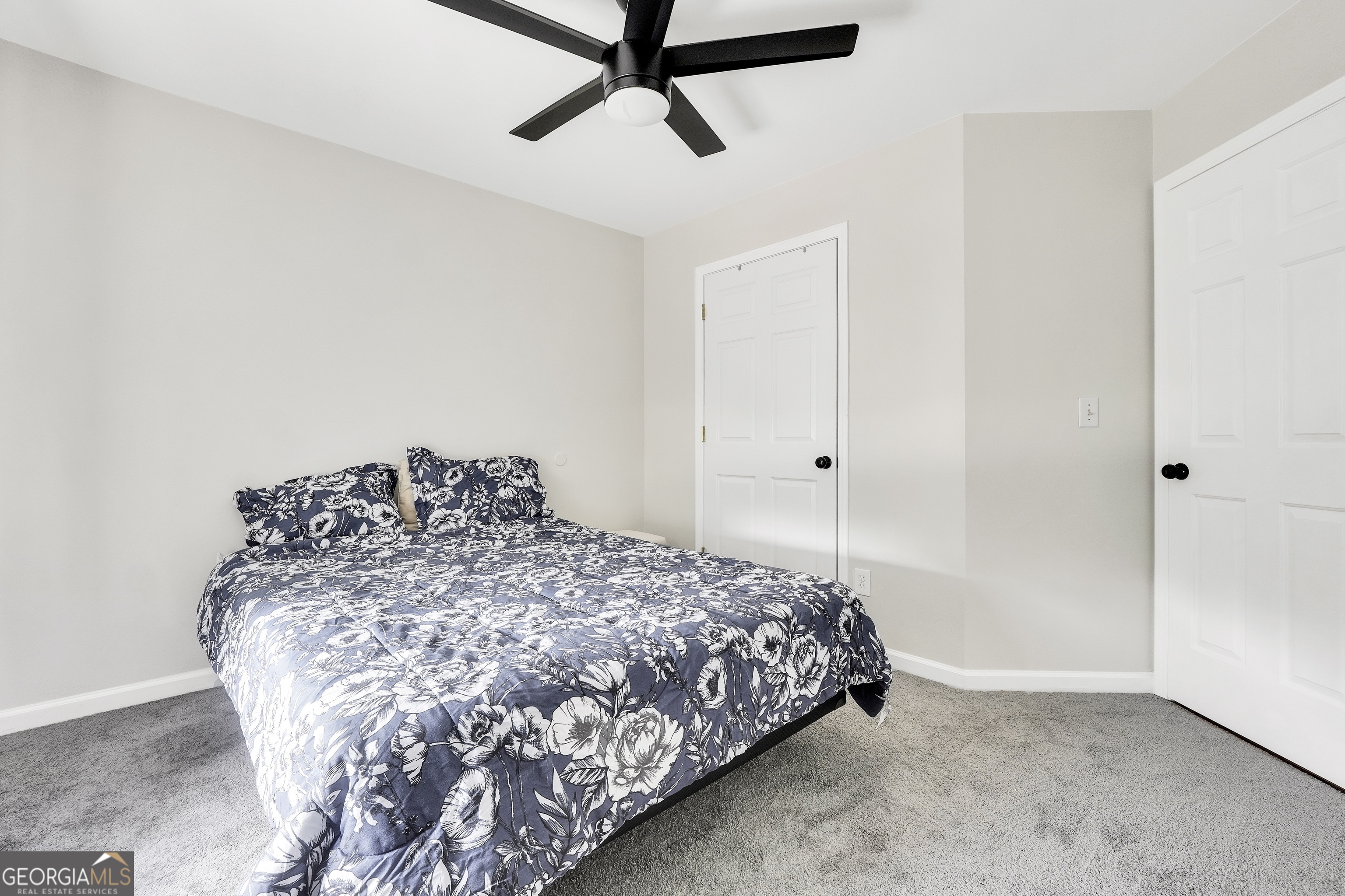 110 Westeria Way Jackson, GA 30233 - Photo 24 of 45 a bed sitting in a bedroom next to a window