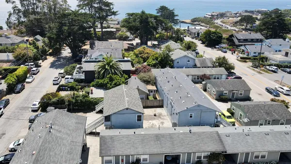 an aerial view of multiple houses with outdoor space