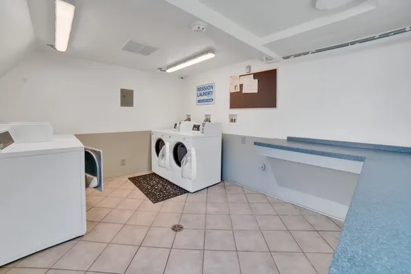 a room with a washing machine and a sink