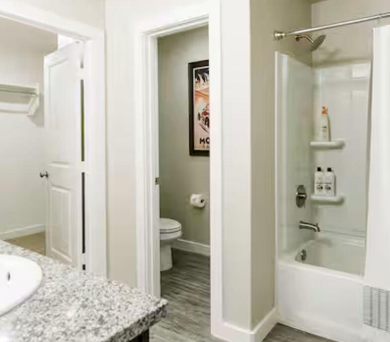 2016 132nd Street Lubbock, TX 79423 - Photo 11 of 28 a bathroom with a granite countertop sink toilet and shower