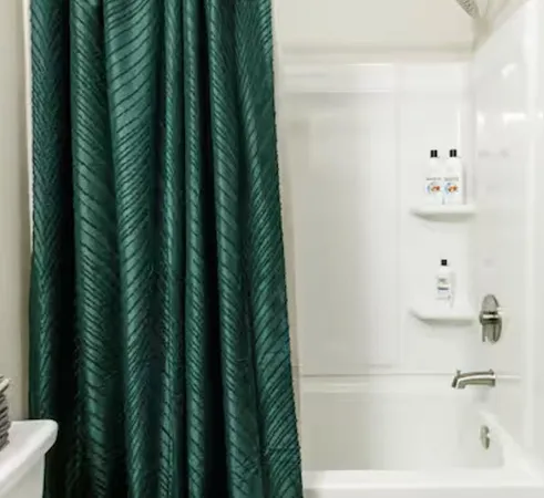 a bathroom with a granite countertop toilet sink and mirror