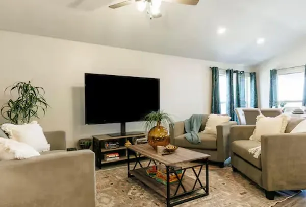 a dining room with furniture and potted plant