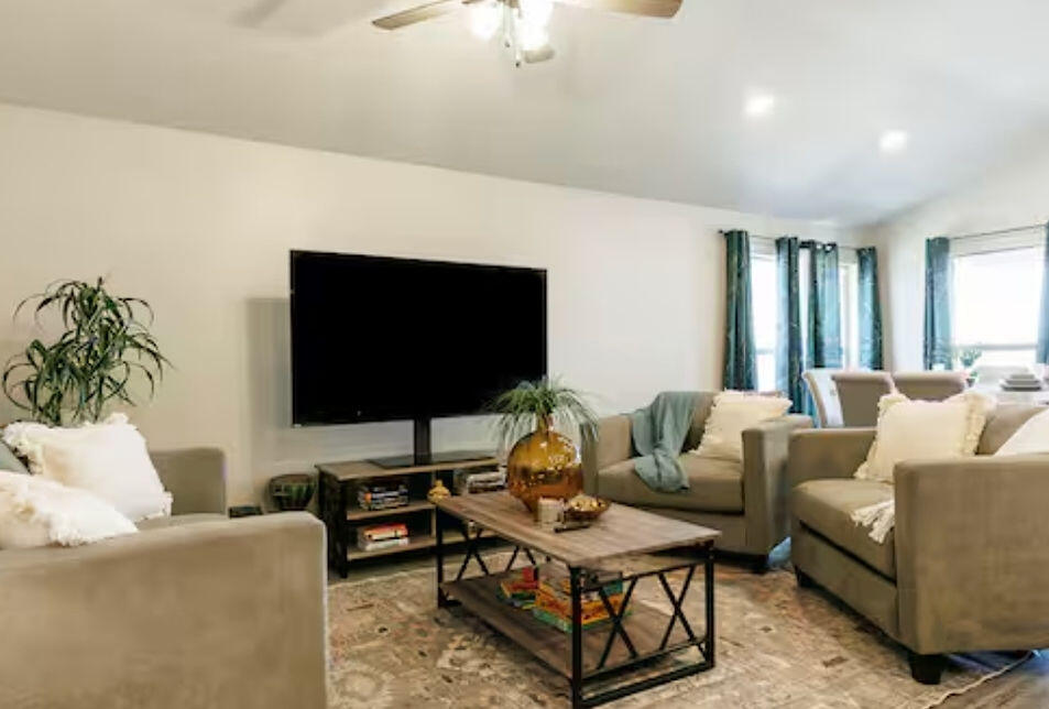 2016 132nd Street Lubbock, TX 79423 - Photo 18 of 28 a living room with furniture and a flat screen tv