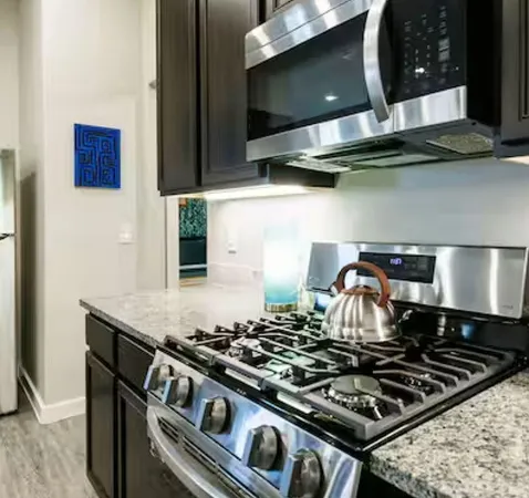 a stove top oven sitting inside of a kitchen